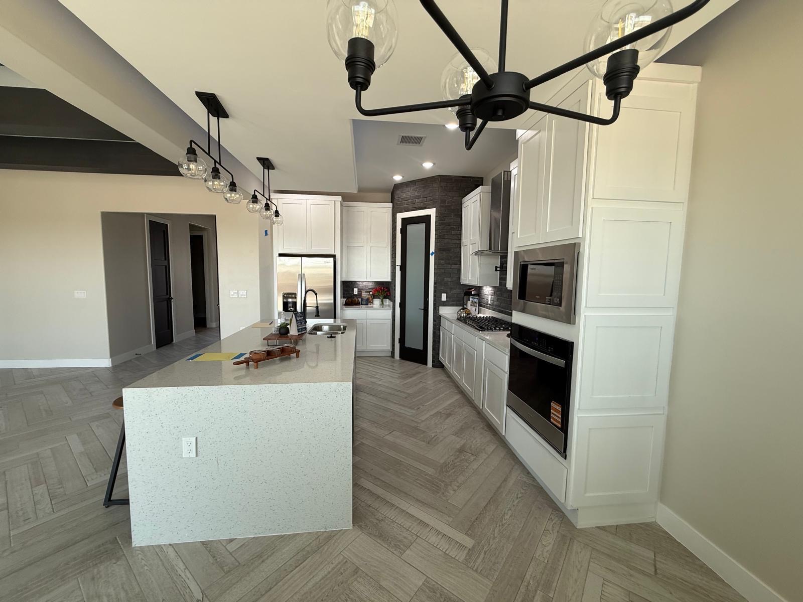 Finished kitchen remodeling project with custom cabinets and quartz countertops